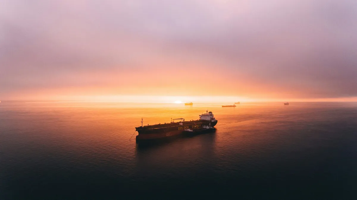 Container ship on the open sea at sunrise