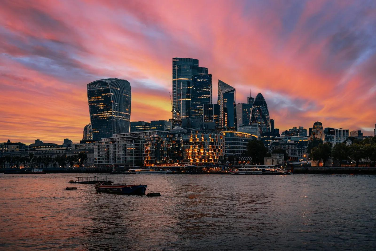 The City of London skyline across the River Thames at sunset